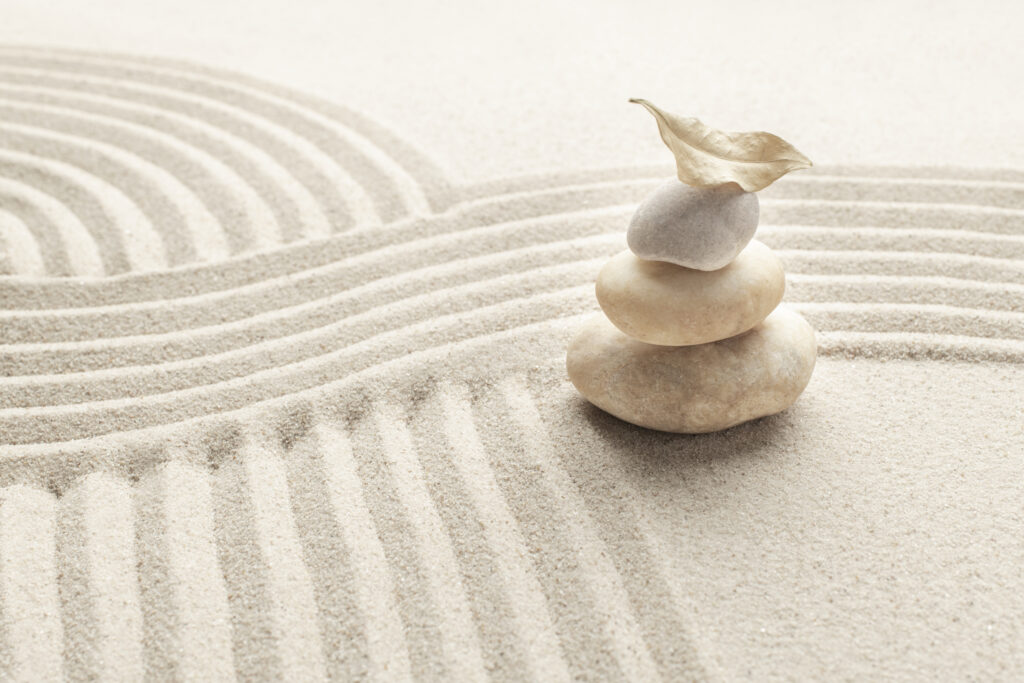 stacked zen marble stones sand background in mindfulness concept